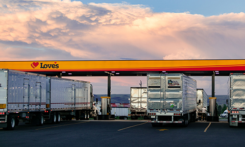 Trucks fueling in the Diesel lane with the Love's canopy visible.