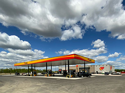 loves travel stop gas pumps and building under cloudy blue sky