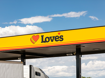 Love's canopy with a truck pulling in