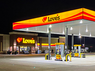 Love's Travel Stop store front with gas lines in front. 