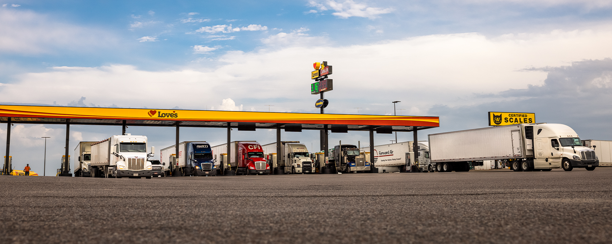 commercial trucks fueling at Love's Travel Stops during daytime at diesel bays