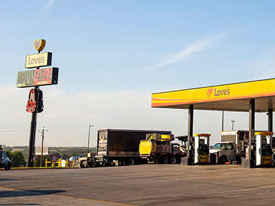 Love's Travel Stop canopy with Diesel trucks in the lanes. 